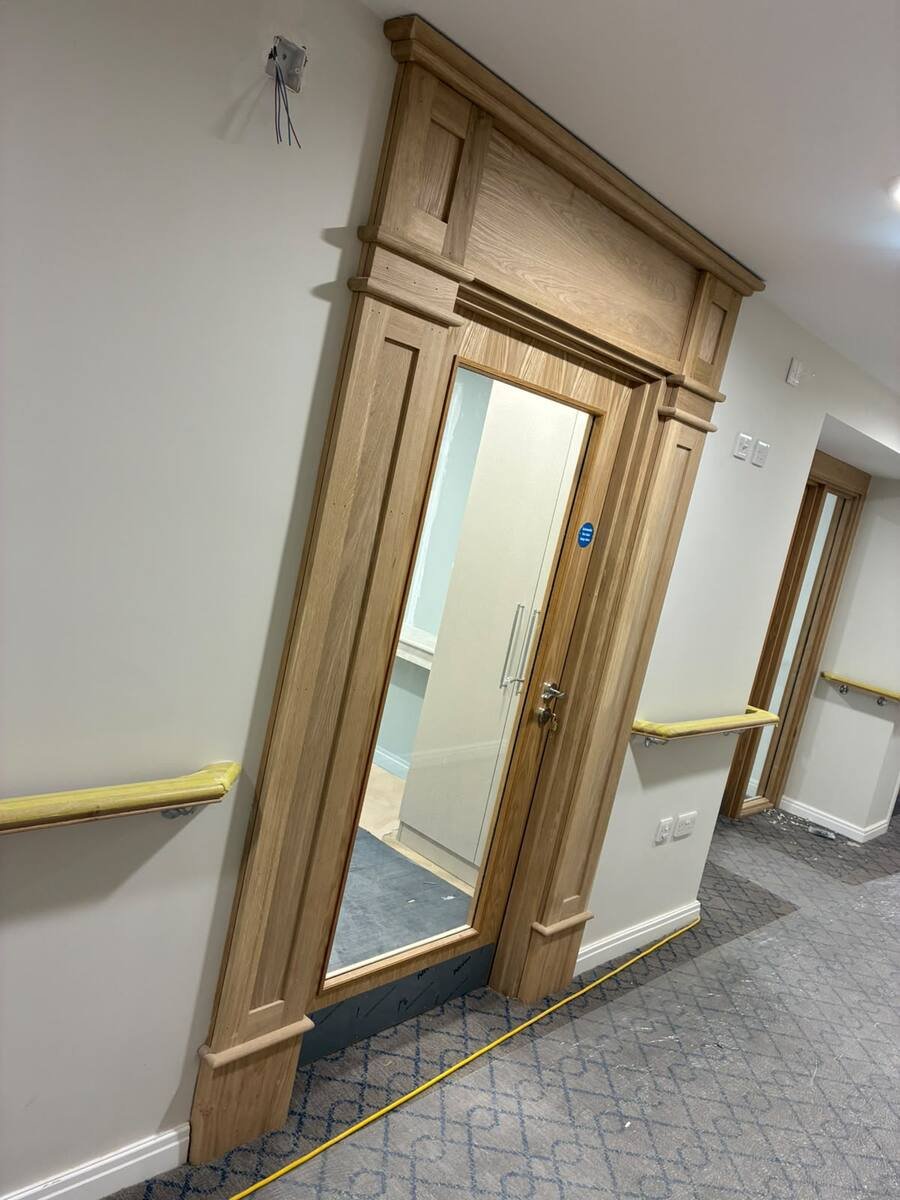 Ornate oak door surround in corridor