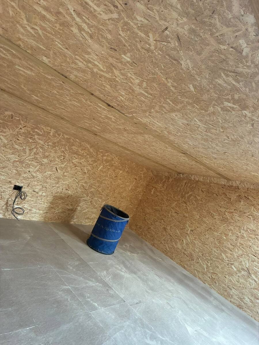 Barn extension room interior with sloped ceiling