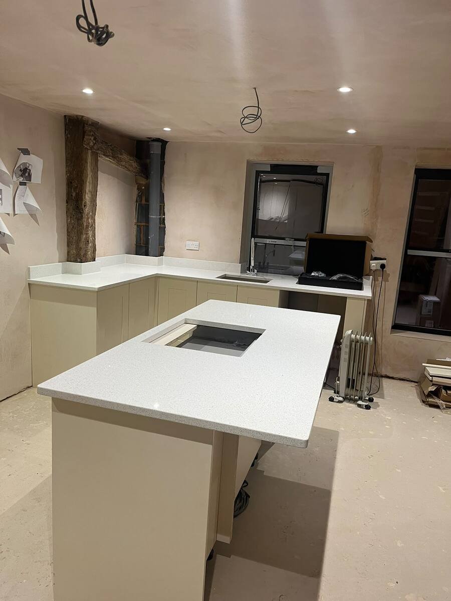Sage green shaker kitchen with quartz worktops