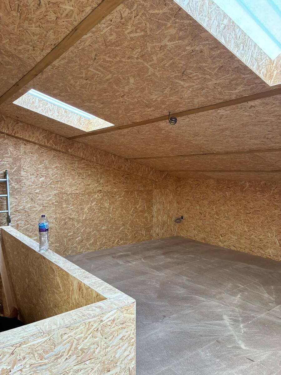 Barn extension interior with skylights